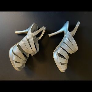 New silver glitter style 4” heel. Never worn. Slip on with elastic on the heel.